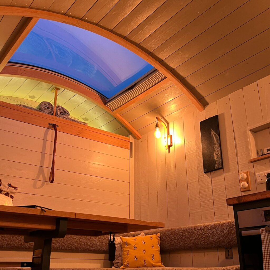 Warmly lit inside of a Shepherd's Hut
