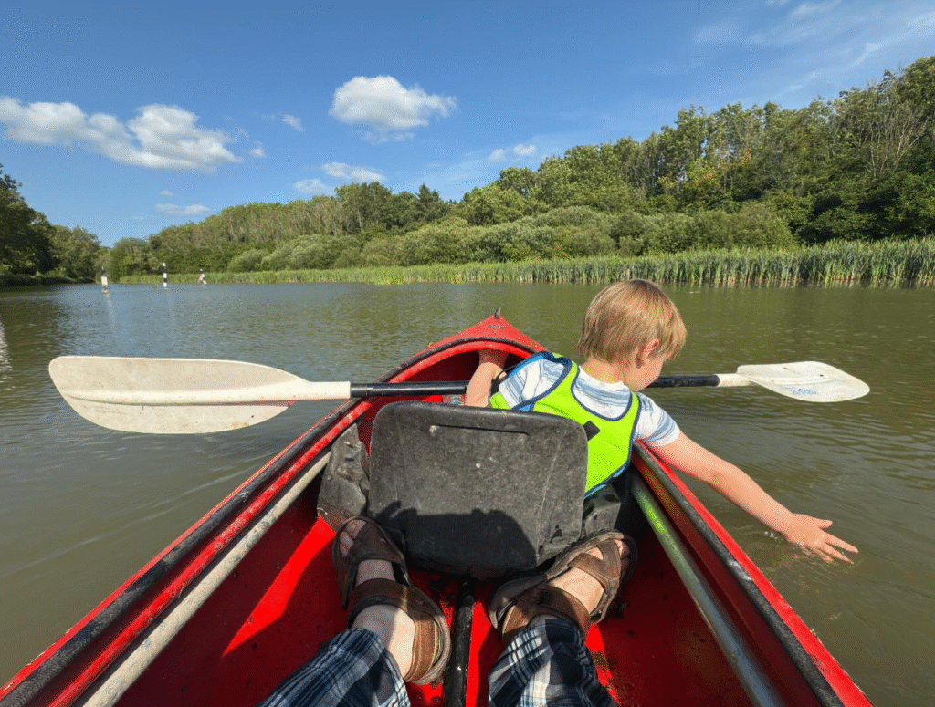 A child in a kayak on the kKennet and Avon canal
